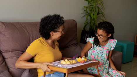 Girl-holding-tray-with-breakfast-for-her-mother